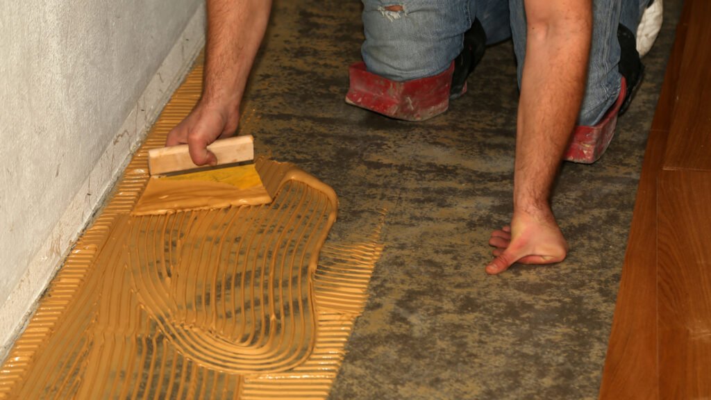 Closeup shot of a worker laying parquet flooring